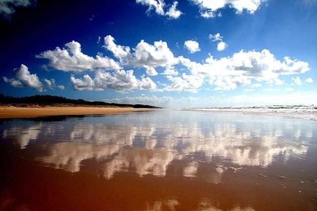 Clouds reflecting in the water on the Fraser island beach - Queensland - Australia