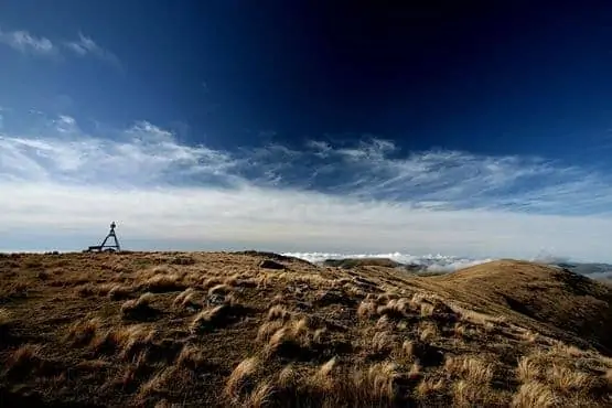 Trig point mount herbert blue skies cloud tussocks grass