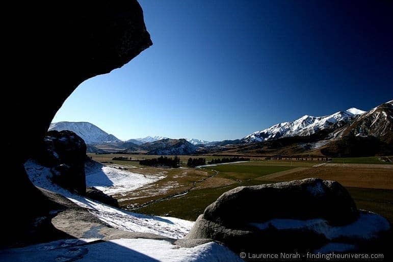 boulders snow mountains sky