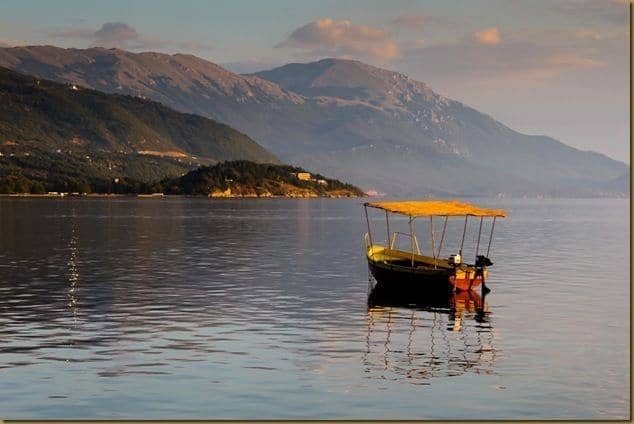 Boat floating on Lake Ohrid at dusk