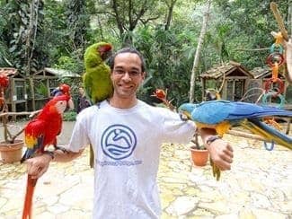 Me with birds at Macaw Mountain Bird Park In Copan Ruinas Honduras