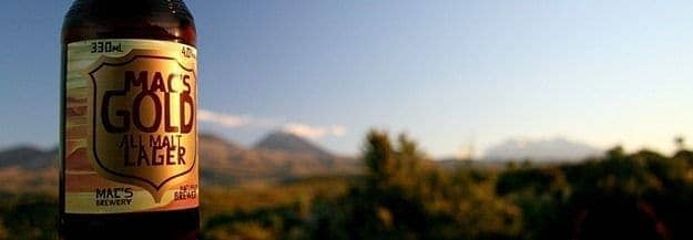 Macs Gold beer bottle with Tongariro National Park in the background