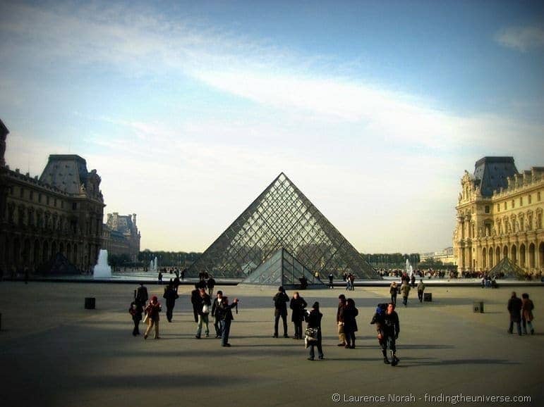Louvre pyramid and tourists Paris