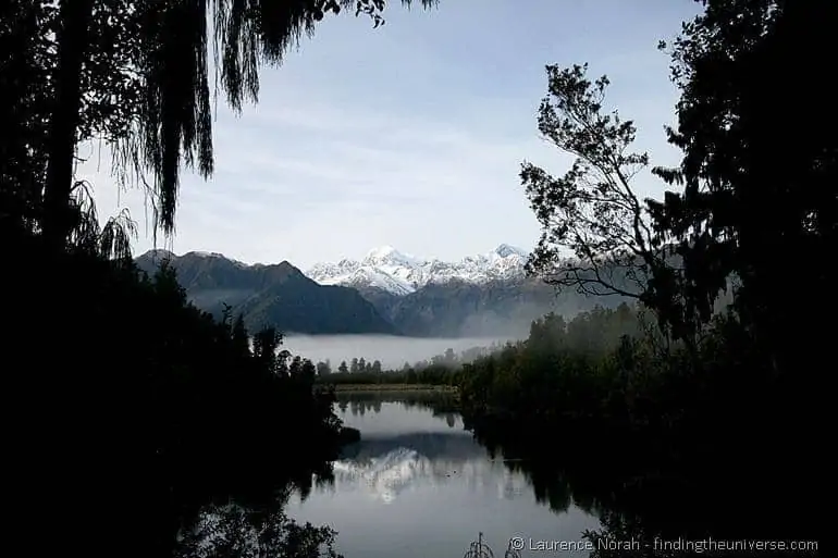 Mirror lake reflection Lake Matheson southern alps New Zealand Mirror reflection of the Southern Alps at Lake Matheson