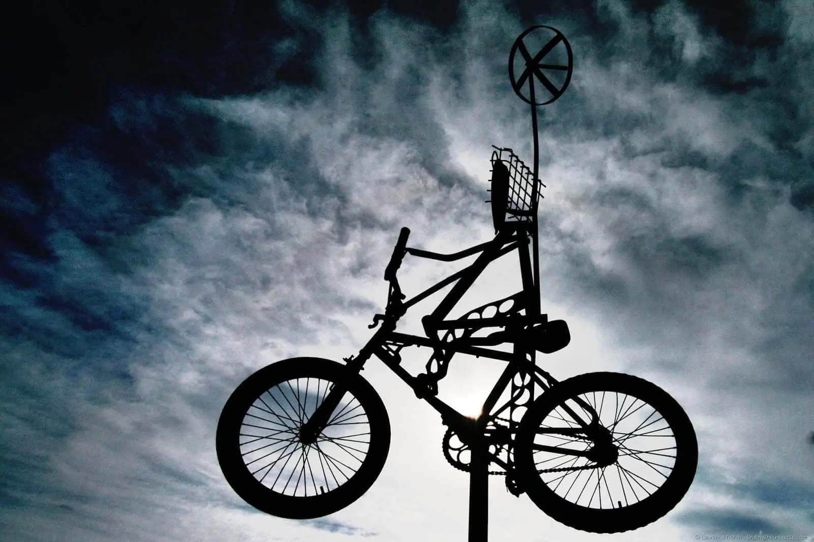 Flying bicycle against sky silhoutte