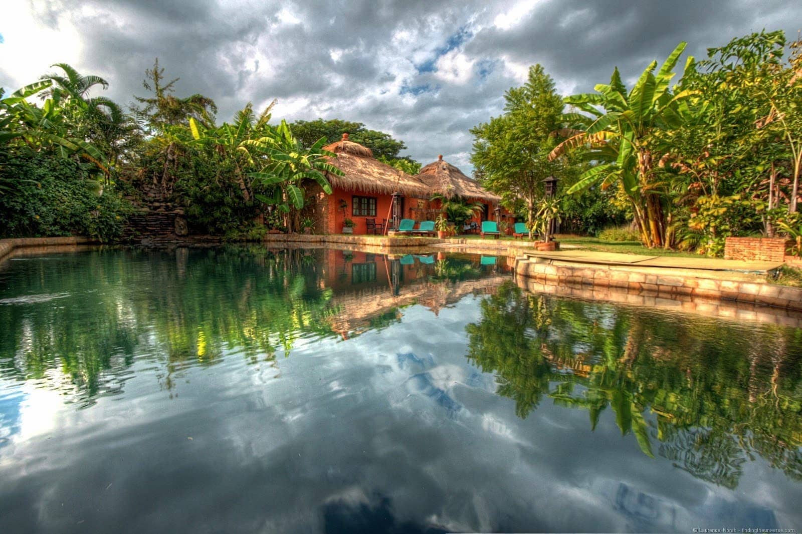 Reflection of chalet pool banana trees hostel by Laurence of findingtheuniverse.com
