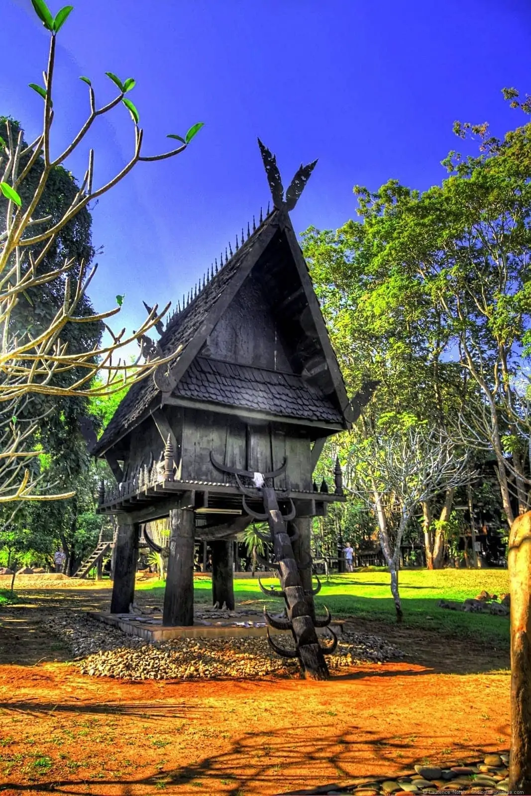 Black temple Chiang Rai small house on stilts