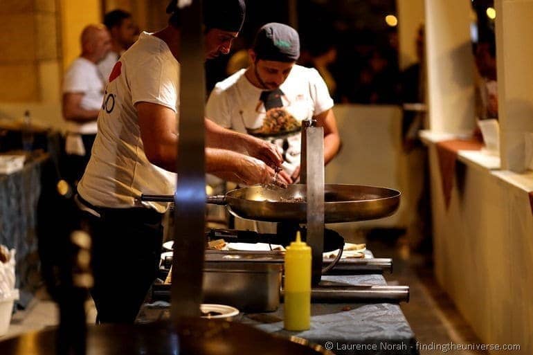 Man cooking over giant pan