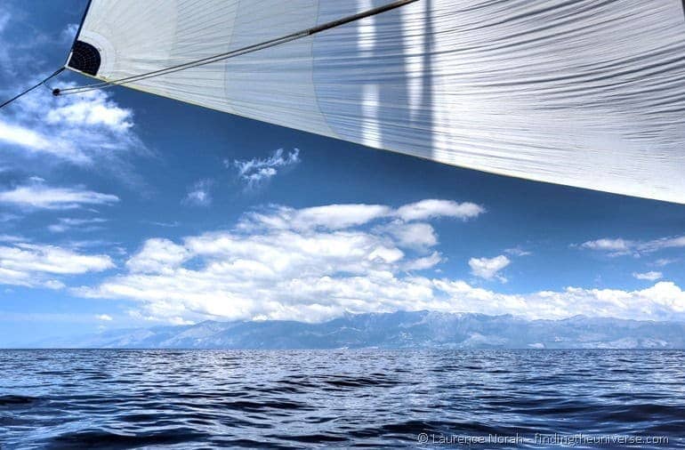 Blue sail sea sky mountains clouds