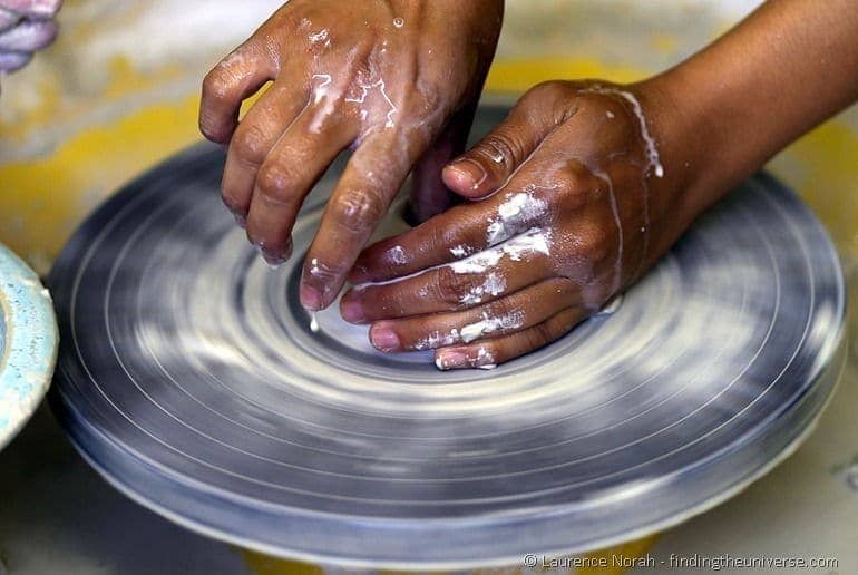 hands making vase on pottery wheel