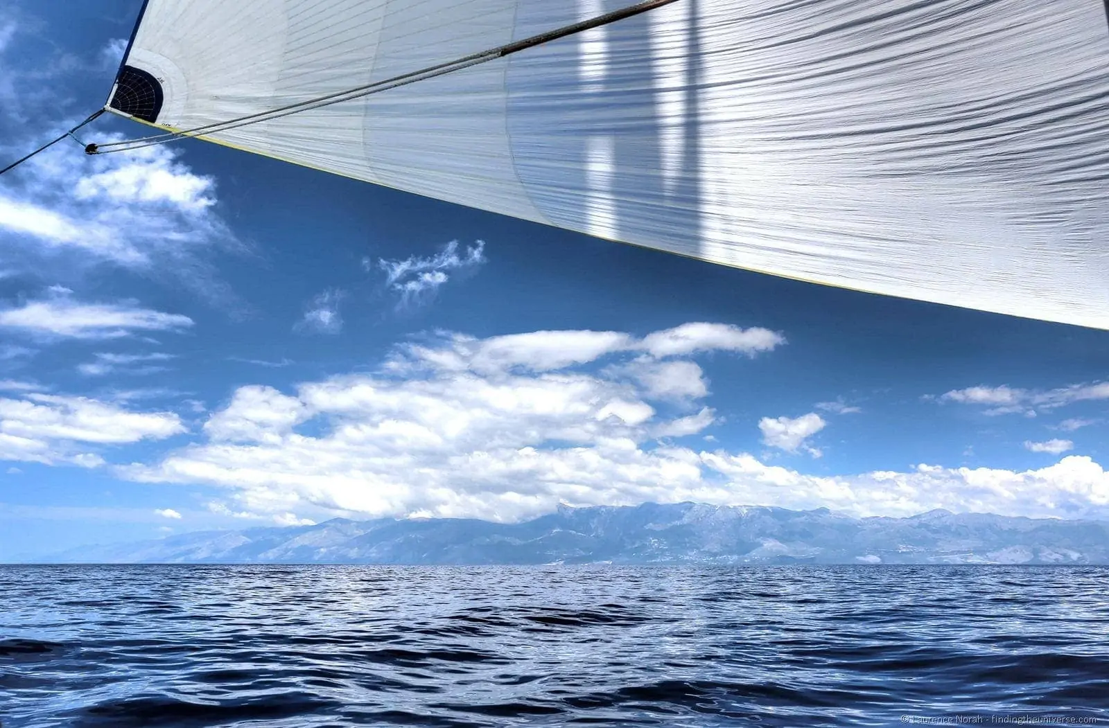 Blue sail sea sky mountains clouds Blue sail sea sky mountains clouds