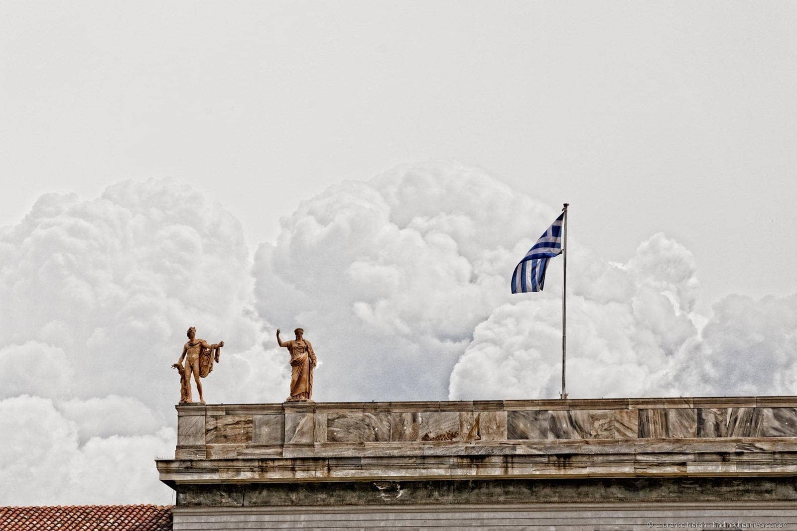Statues and greek flag athens
