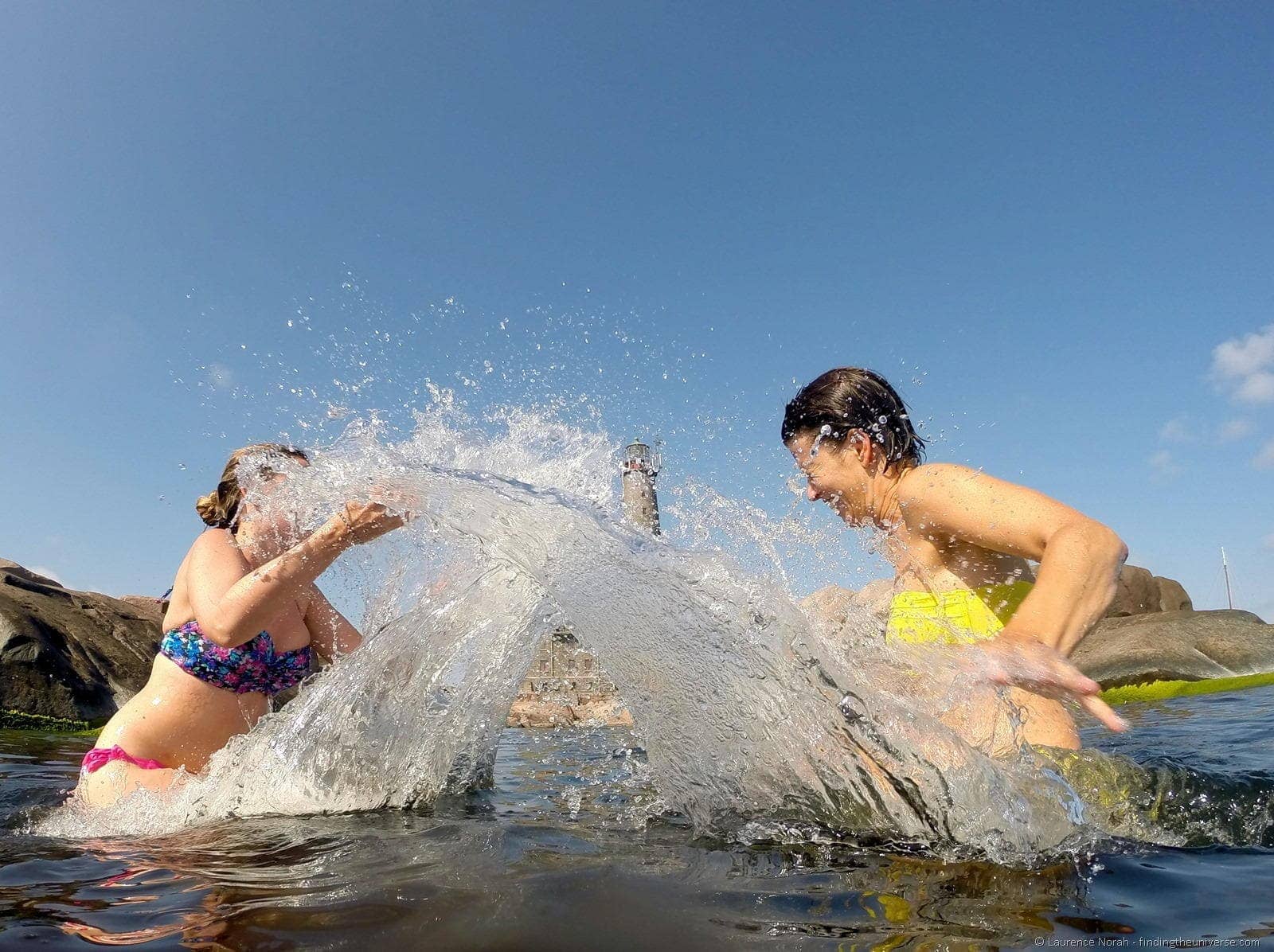 girls splashing water in finland sea swimming
