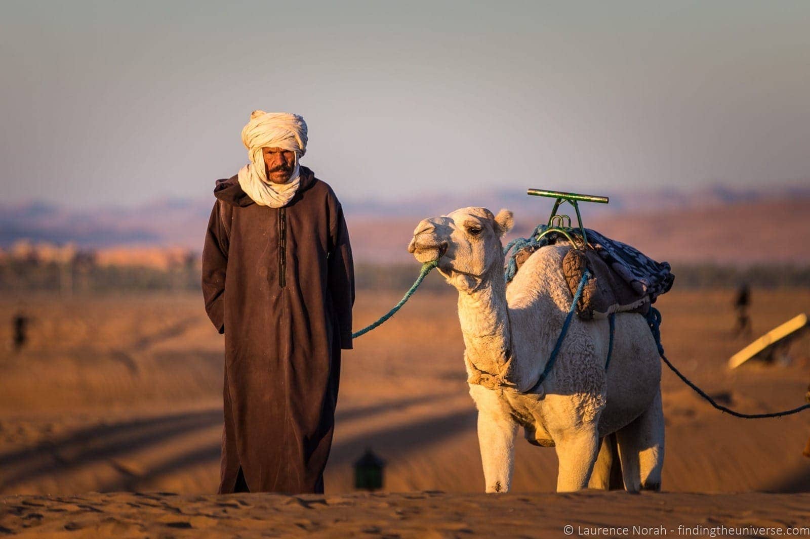 Camel and man in desert Morocco 