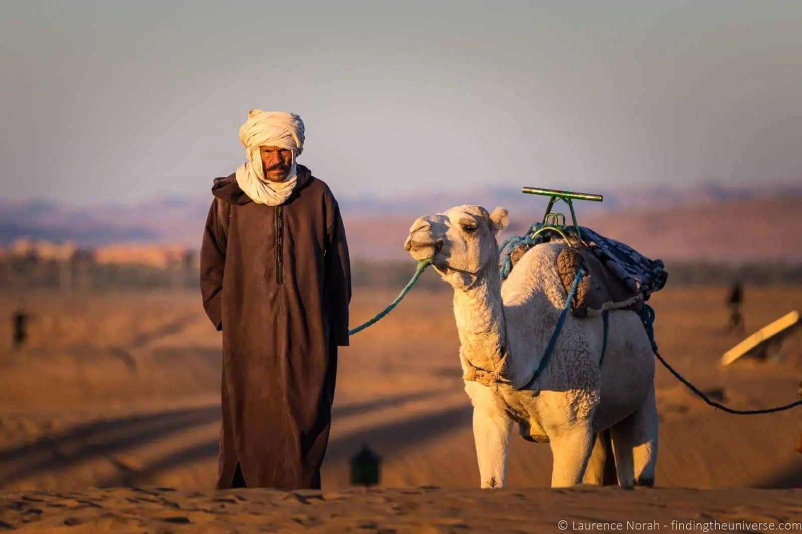 Camel and man in desert Morocco Camel and man in desert Morocco