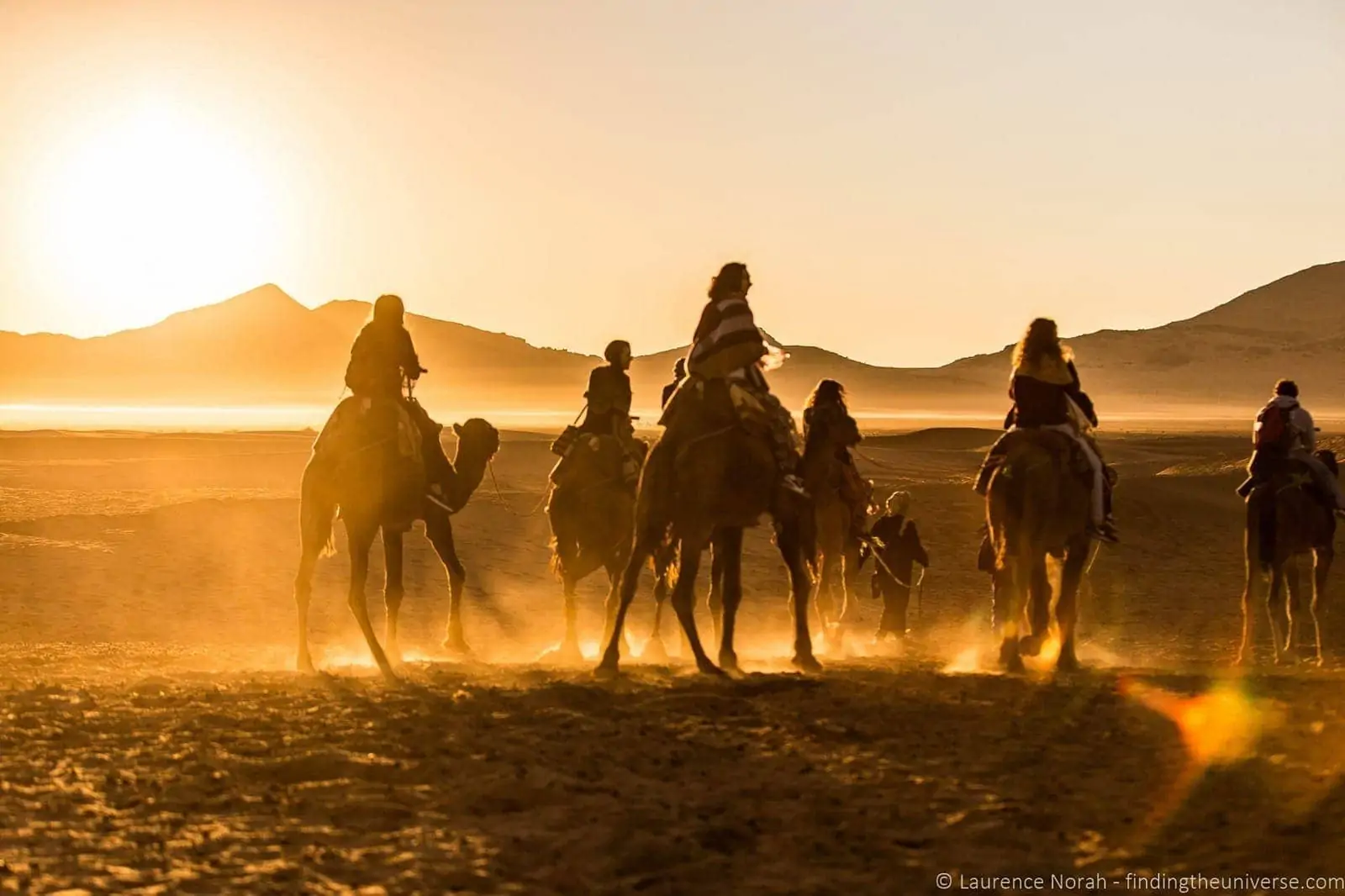 Camels and riders in desert Morocco Camels and riders in desert Morocco