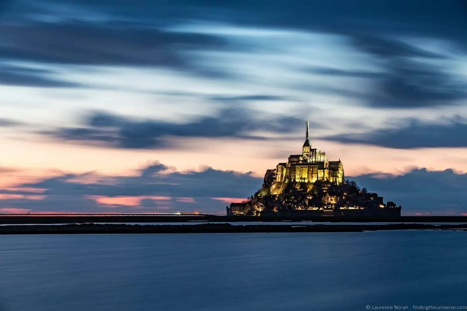 Mont-Saint-Michel lit up against the evening sky