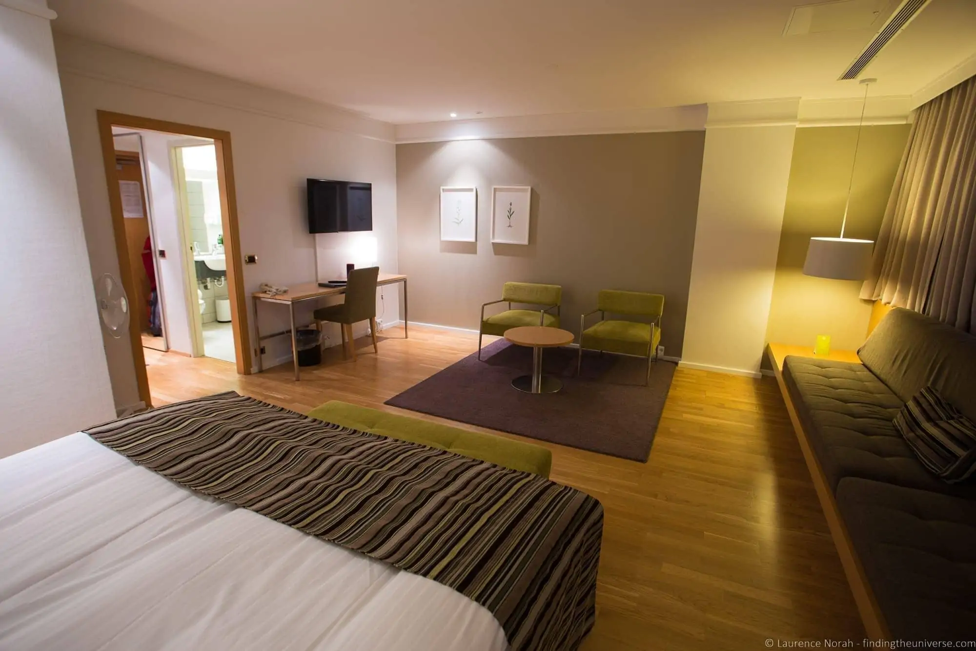 Chain hotel room in Reykjavik with seating area and wooden floor