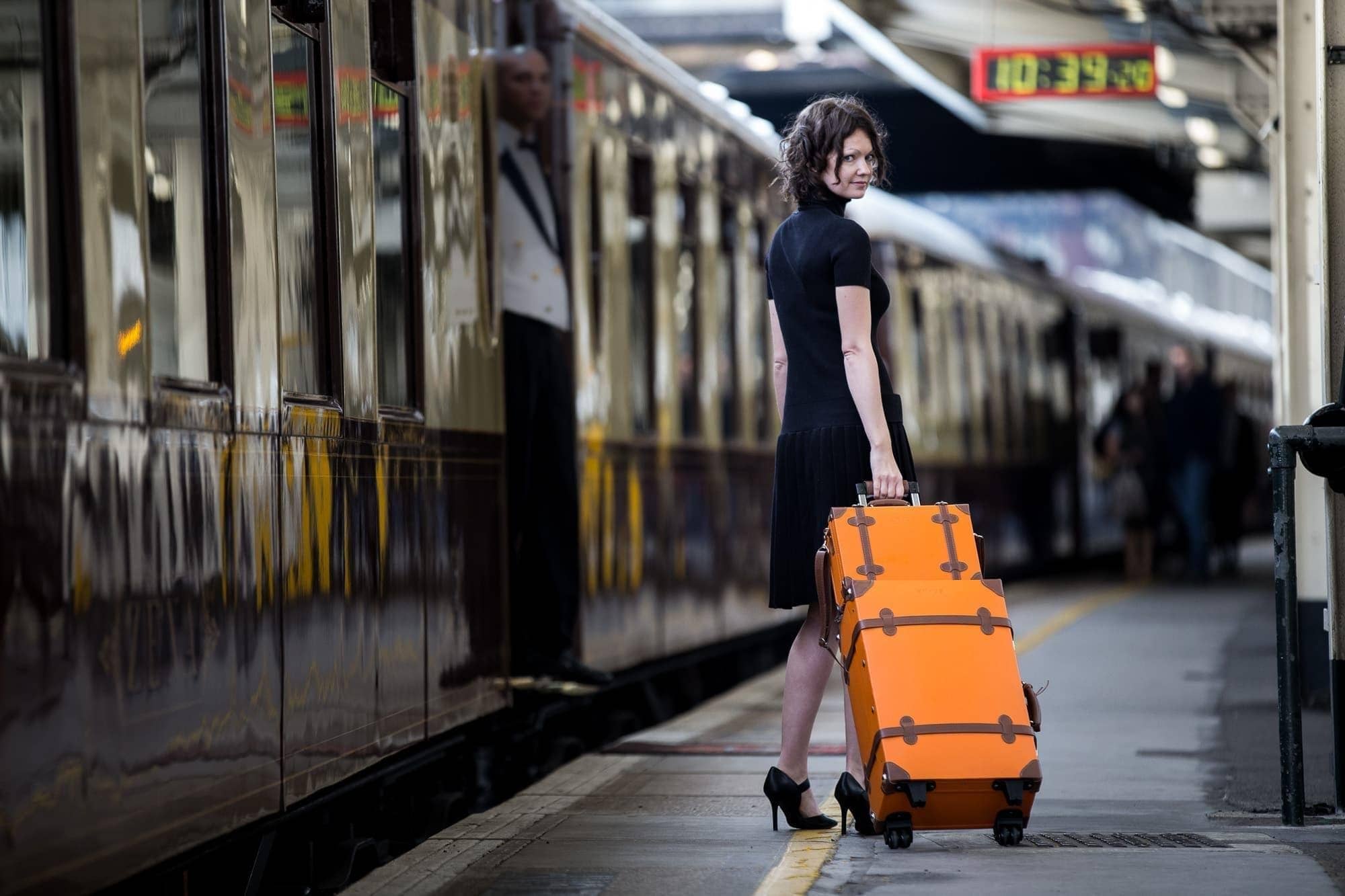Girl with luggage on train platform image
