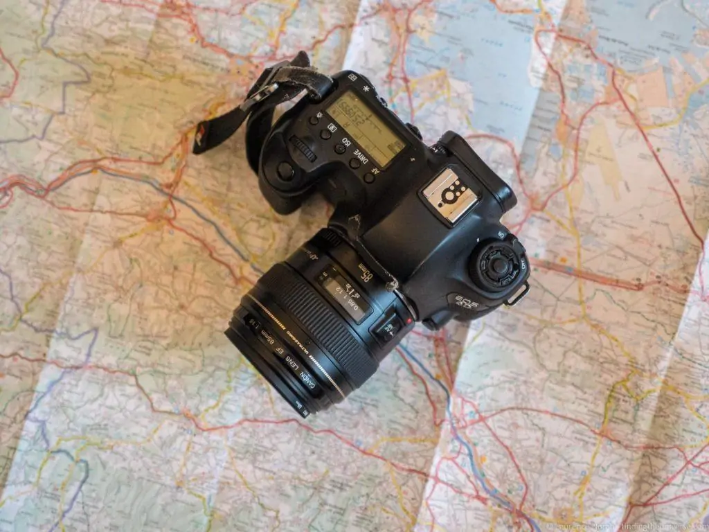 Camera and travel lens packed for a trip