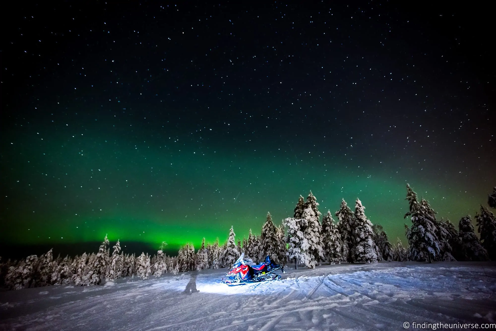 Northern lights Finland snowmobile
