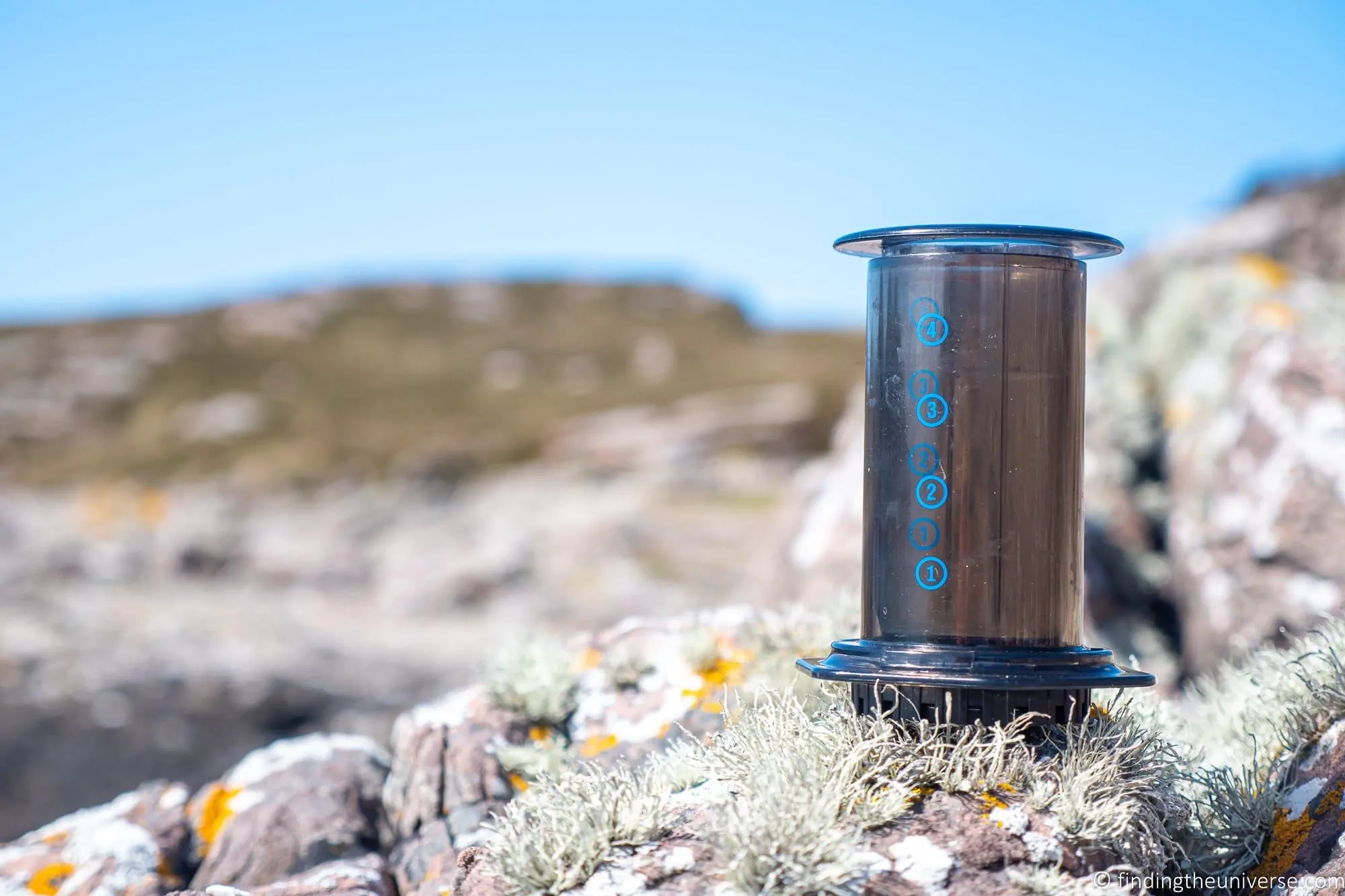 AeroPress travel coffee maker set up on a table while travelling