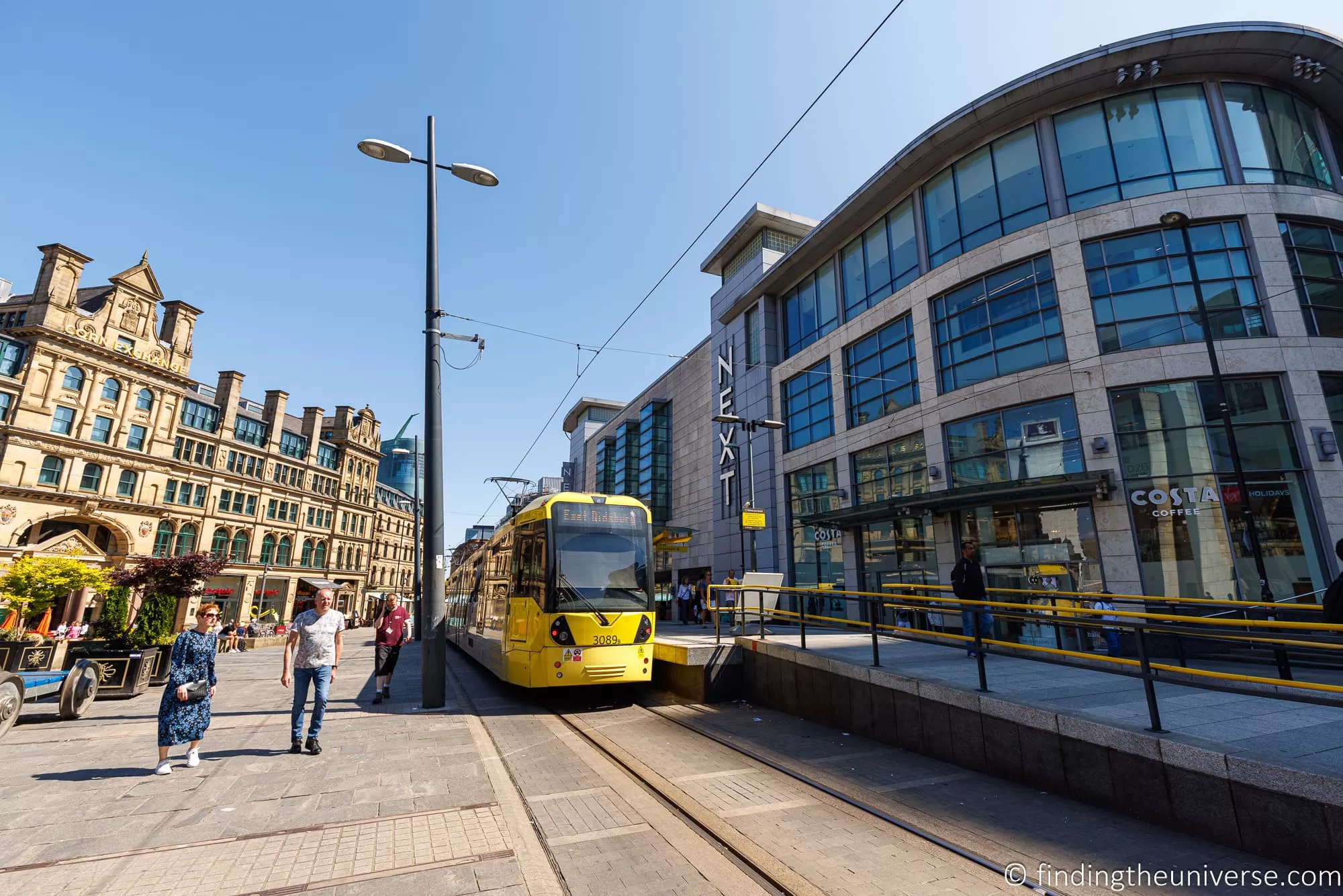 A yellow Metrolink tram in central Manchester