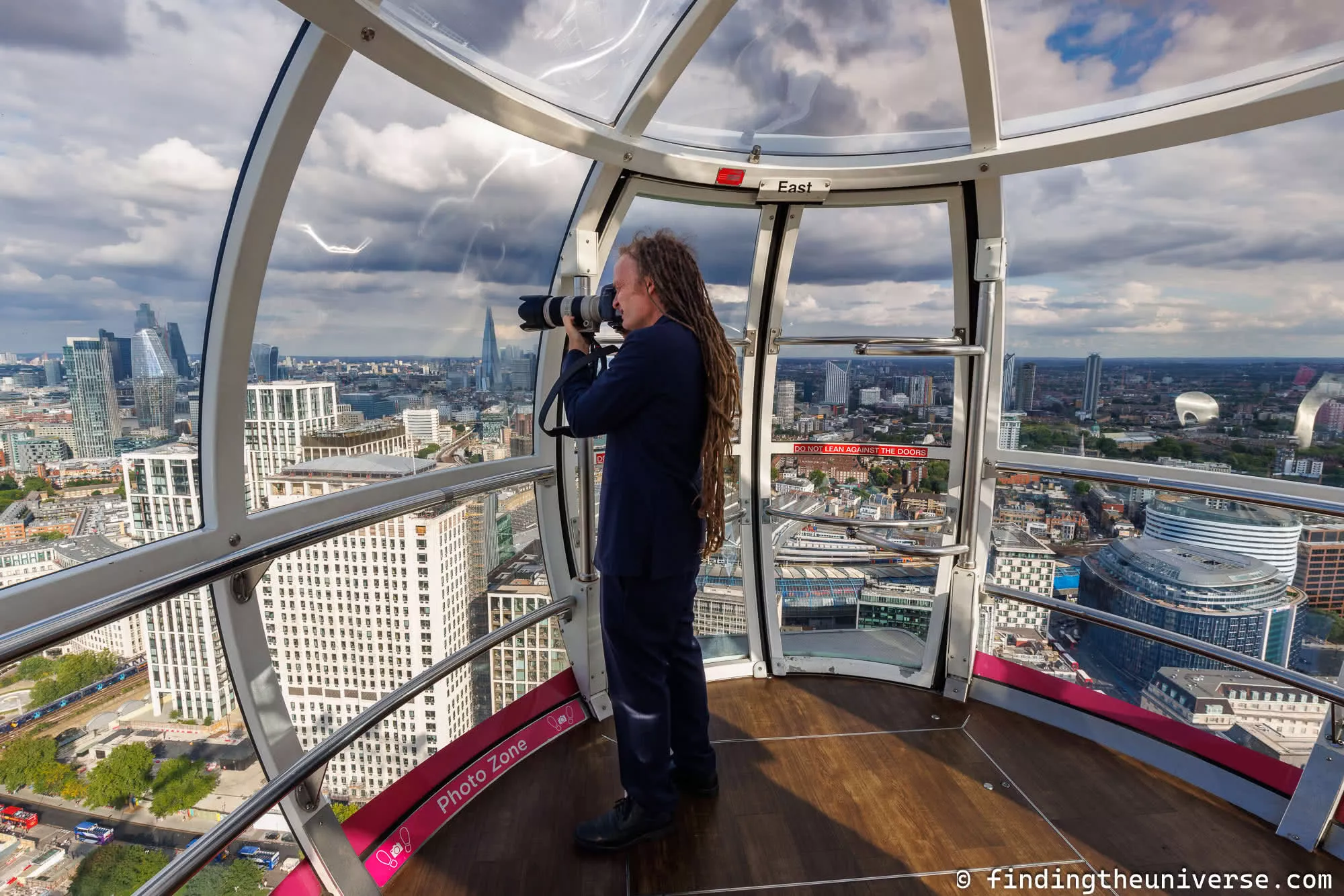 Laurence photographing from inside London Eye by Laurence Norah