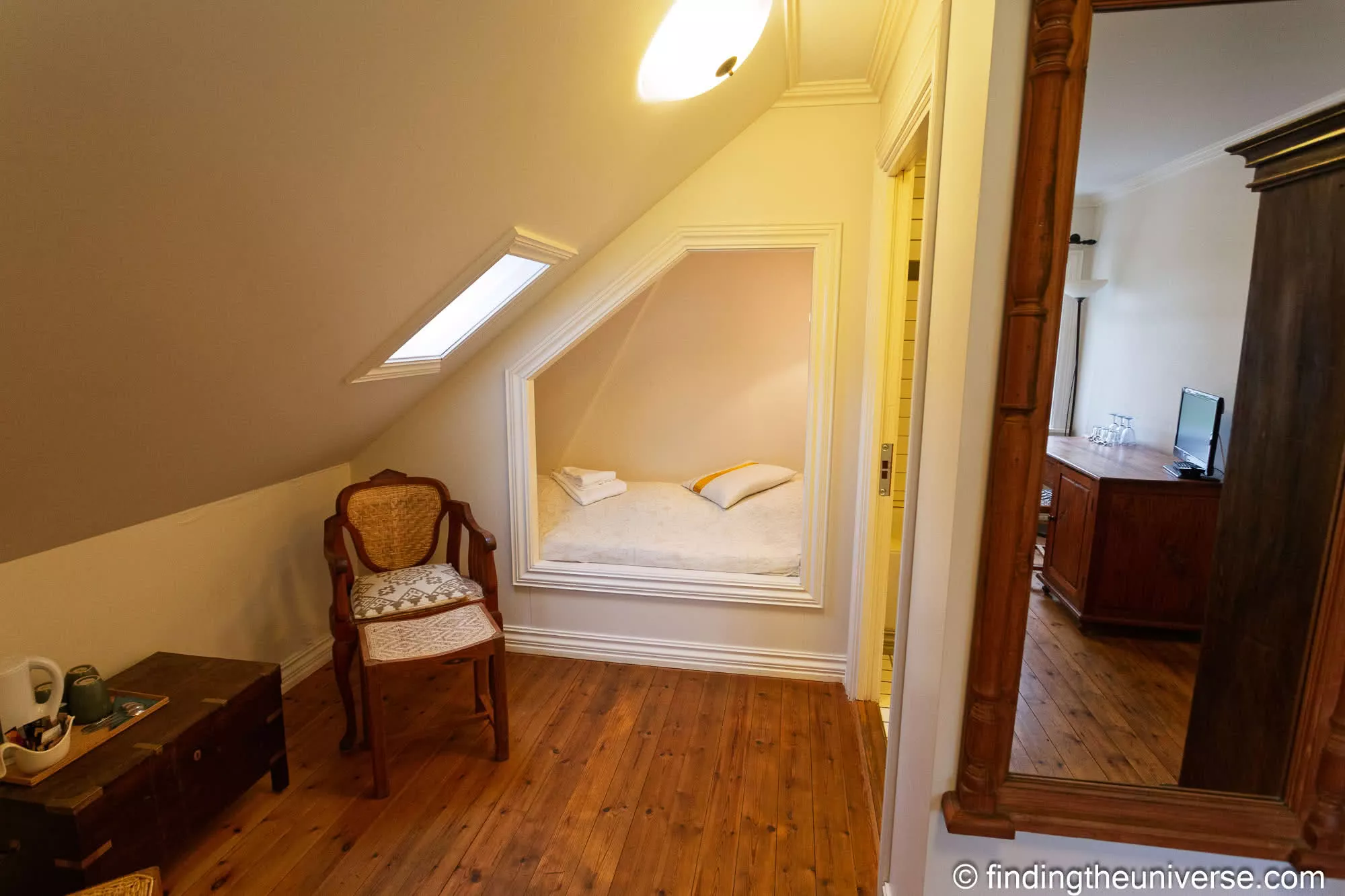 Attic guest room at the Aldan Hotel, with skylight and antique wardrobe