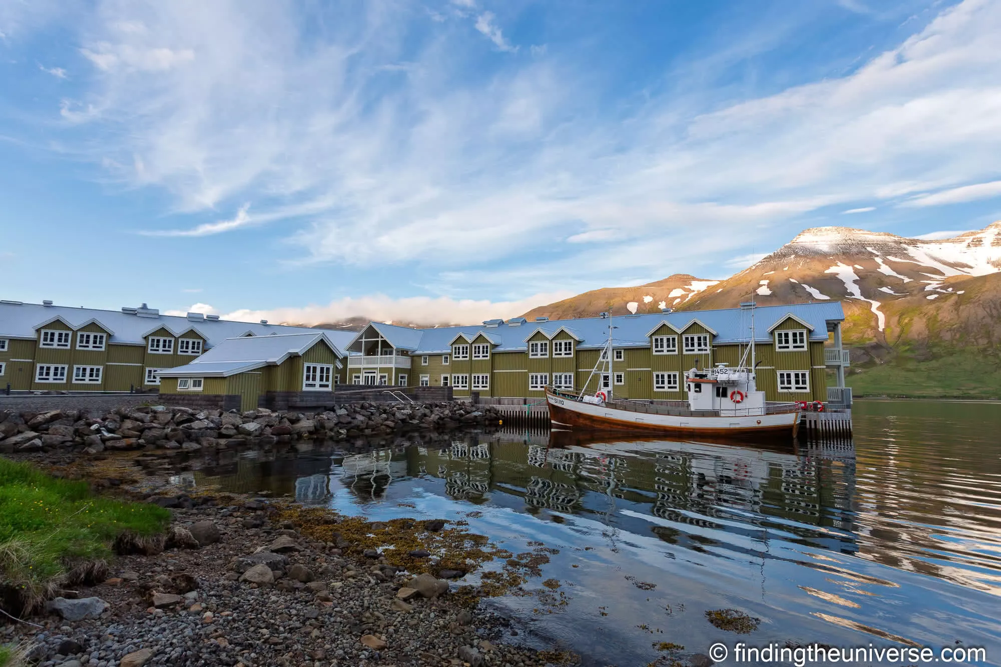 Sigló Hótel reflected in the still water of Siglufjörður harbour