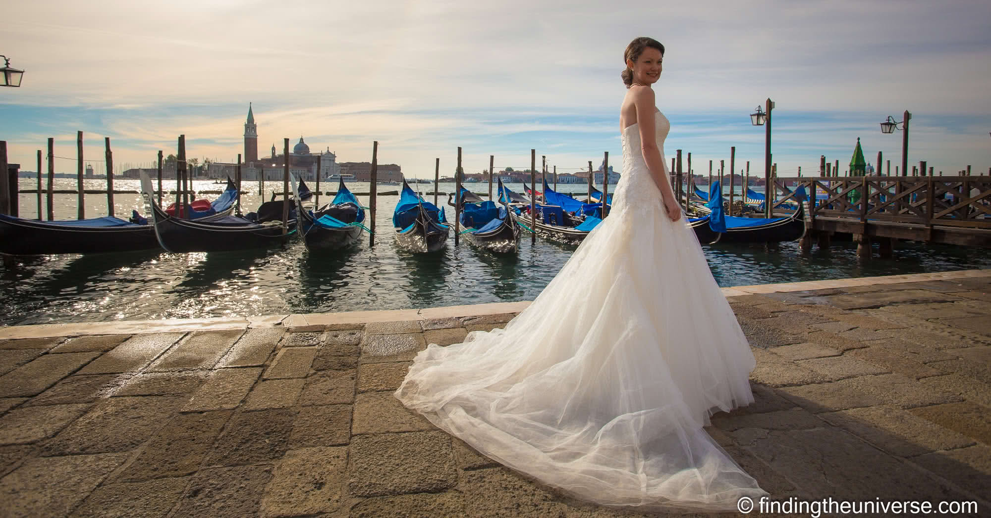 Jessica in wedding dress in front of gondolas Venice