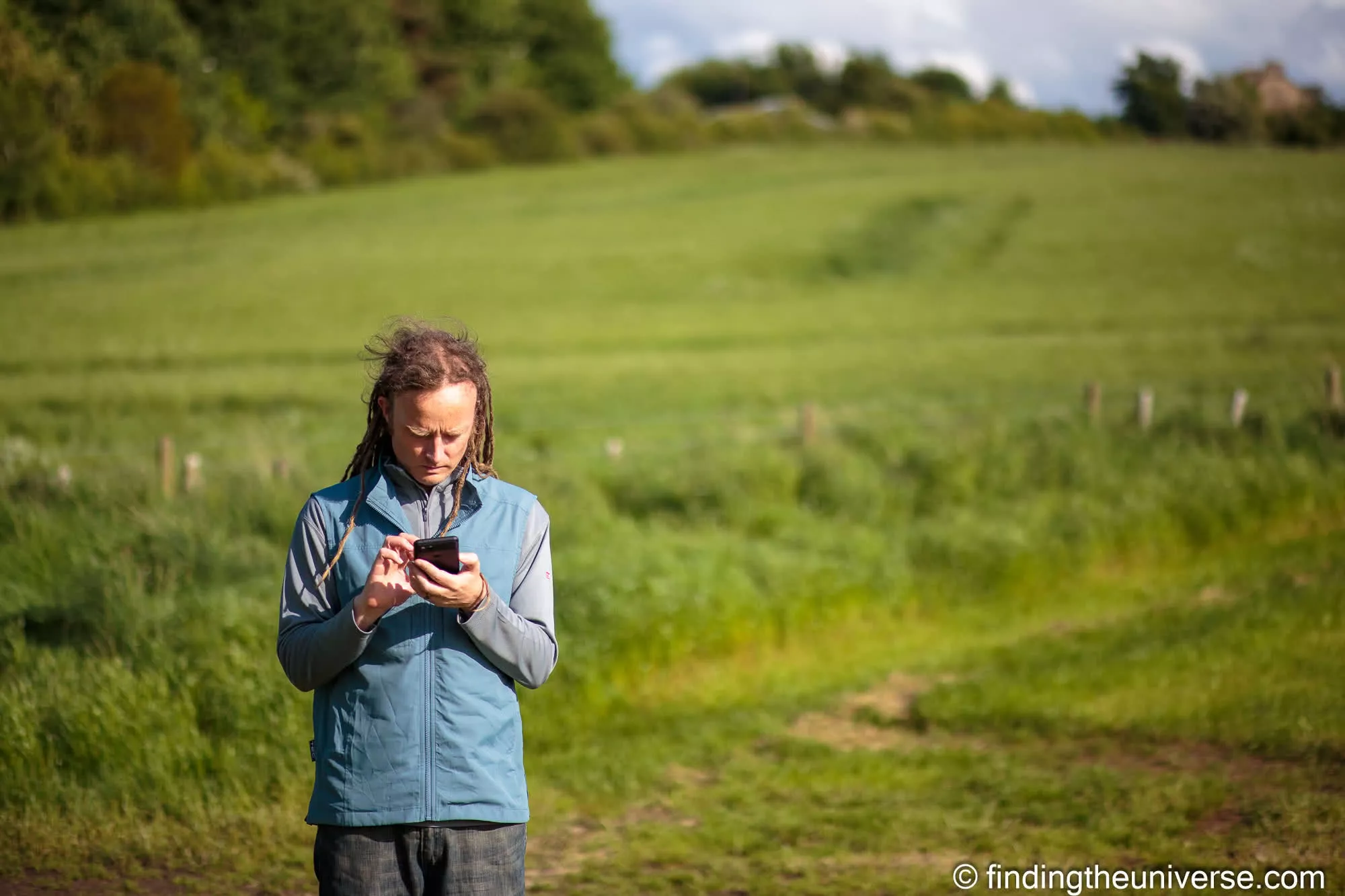 Laurence using phone in rural England by Laurence Norah