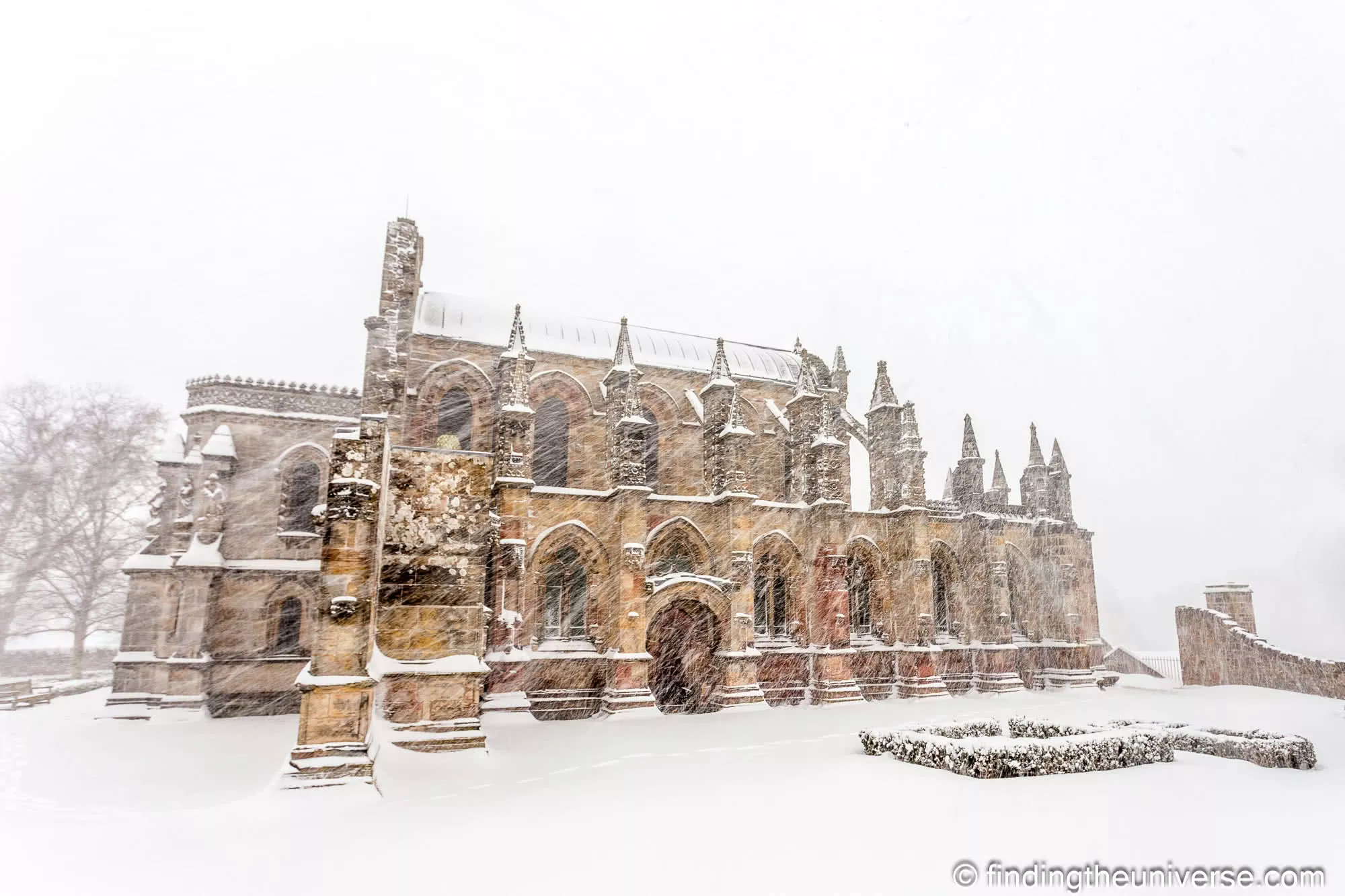 Rosslyn Chapel in heavy falling snow, the stonework dusted white