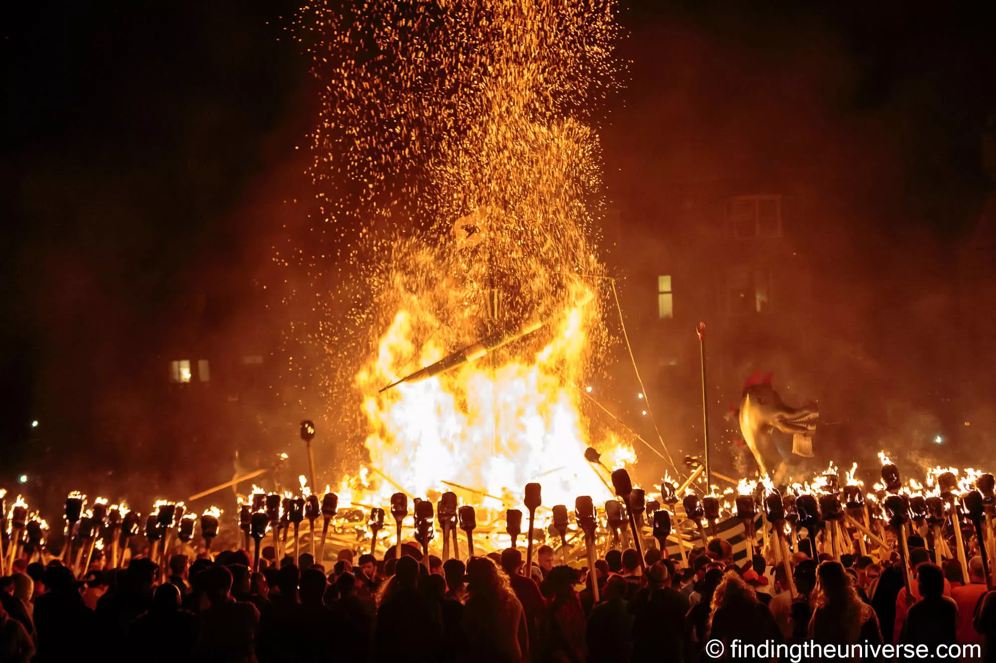 The Up Helly Aa fire festival at night in Lerwick, Shetland, a galley ablaze amid a torch-lit crowd