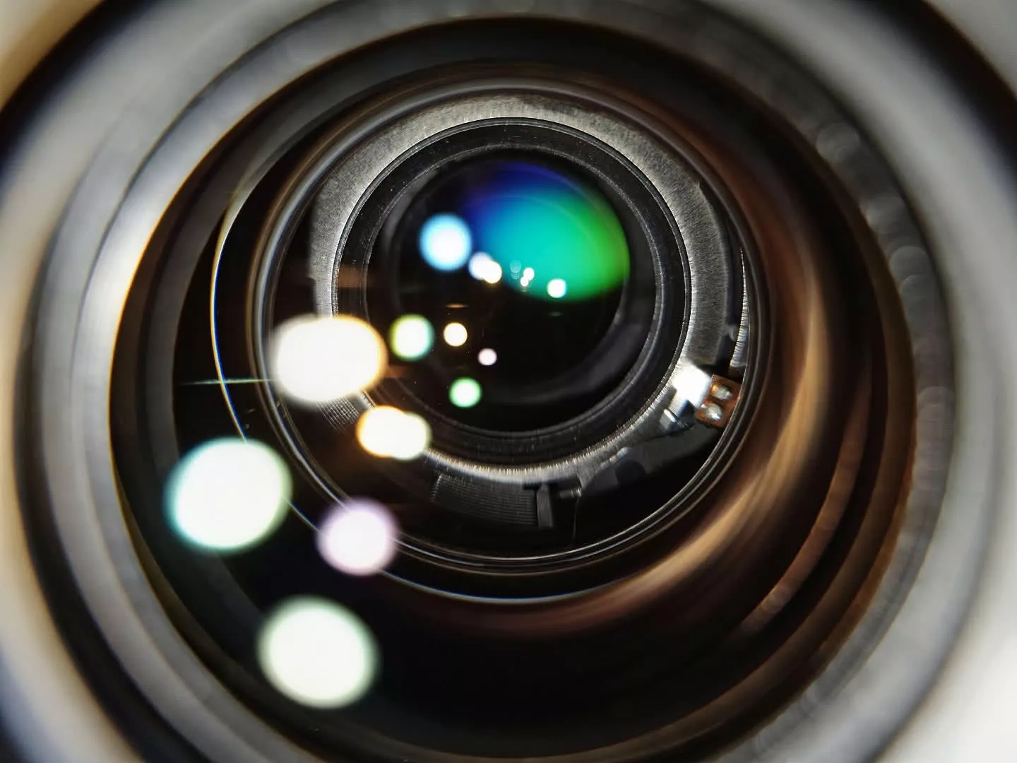 The aperture of an EF 100mm Macro lens wide open at f/2.8, a large circular opening