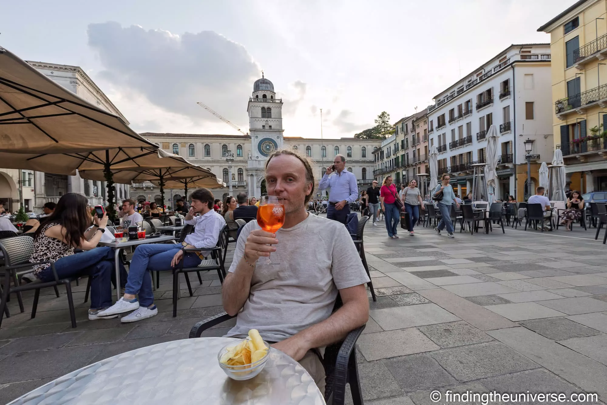 An Aperol spritz at aperitivo hour in Piazza dei Signori, Padua