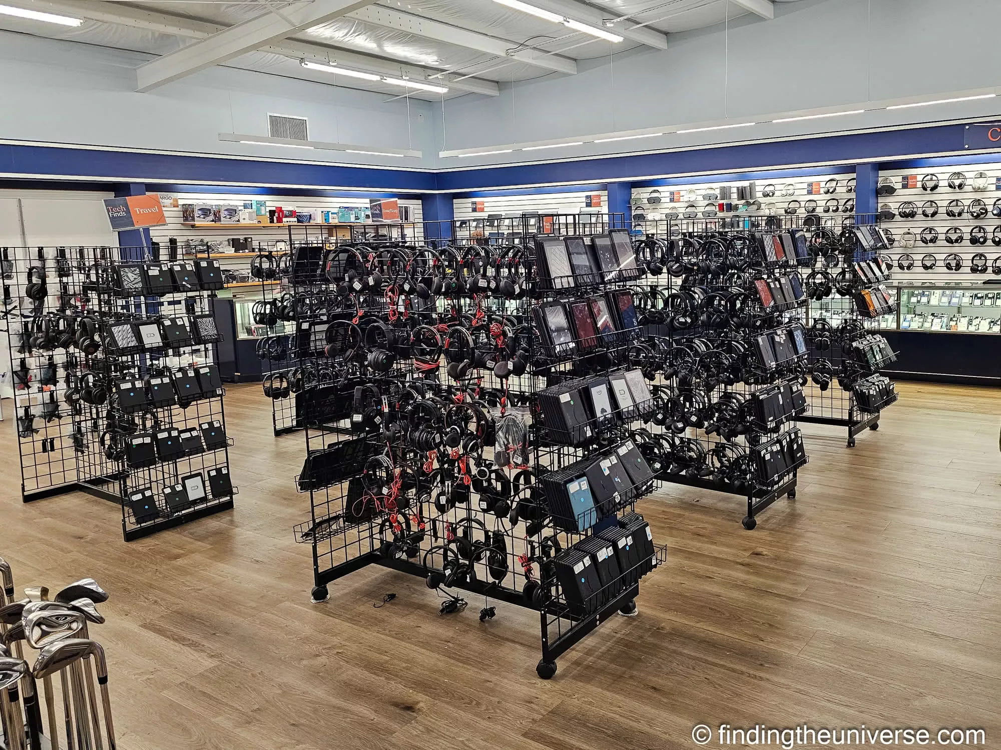 Wall of headphones tablets and electronics at Unclaimed Baggage