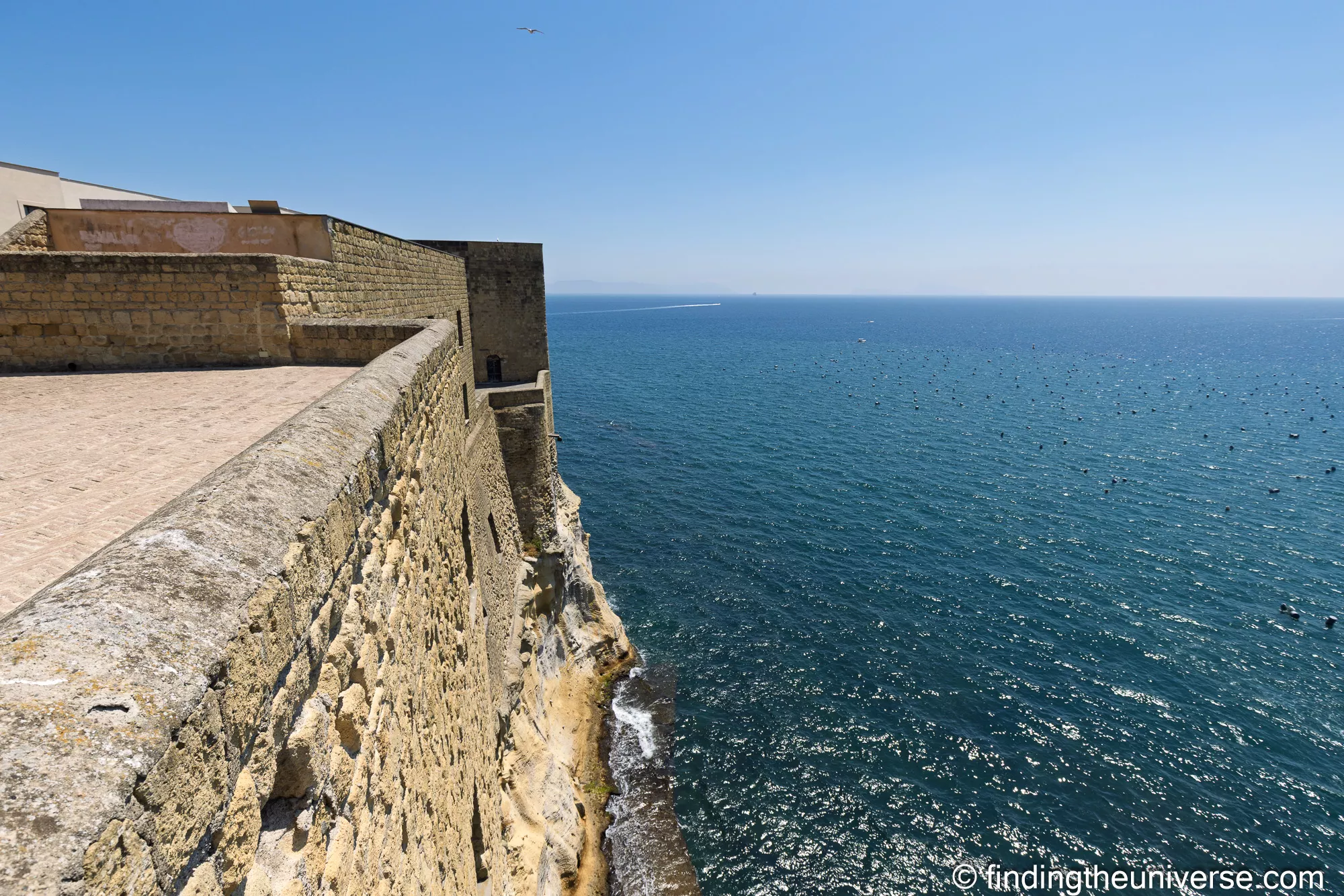 The ramparts of Castel dell'Ovo above the sea in Naples