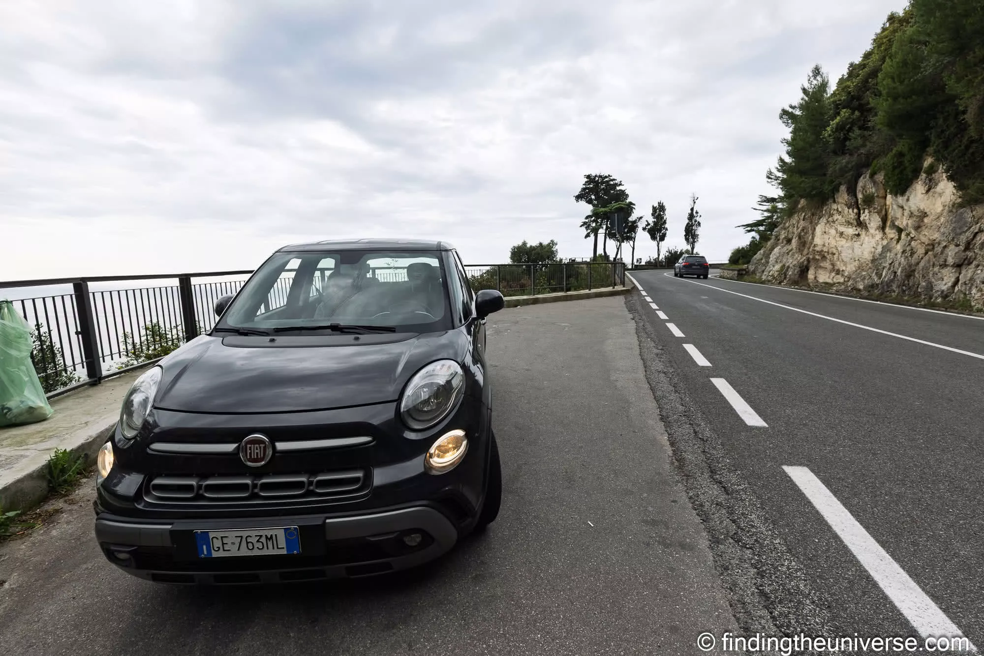 Our black hire car parked beside the Amalfi Coast road