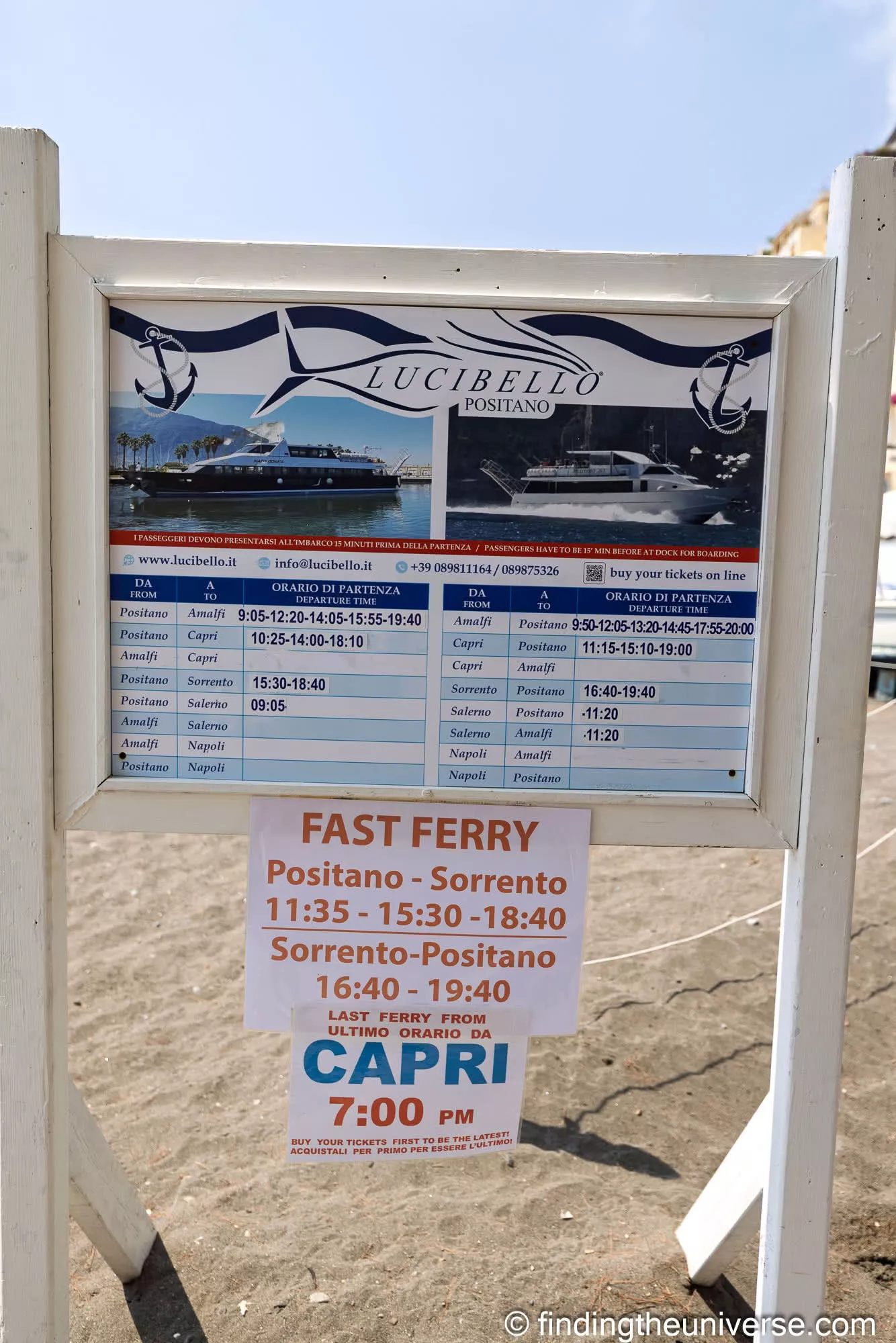 A ferry timetable board on the pier at Positano