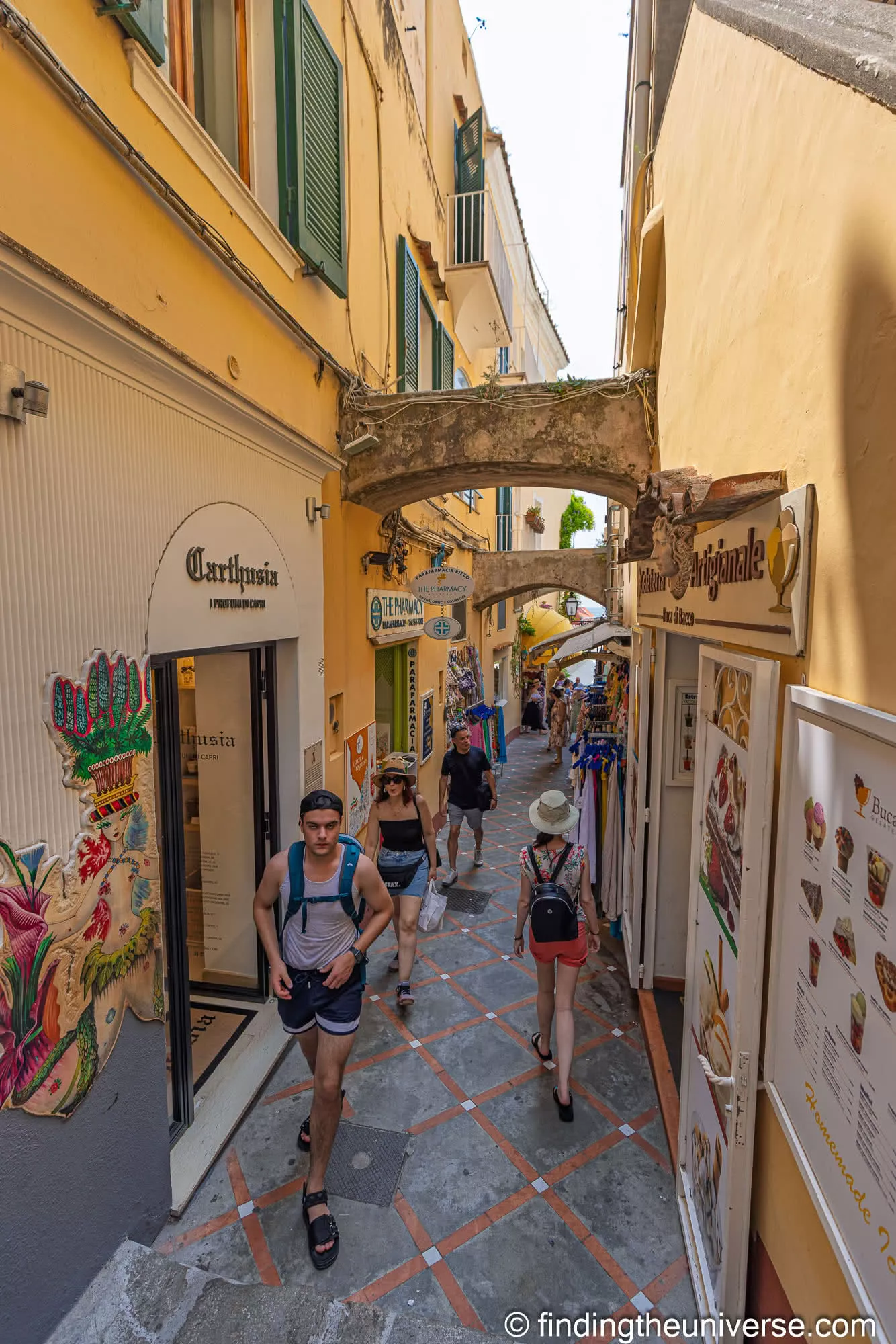 A narrow shopping street climbing through Positano