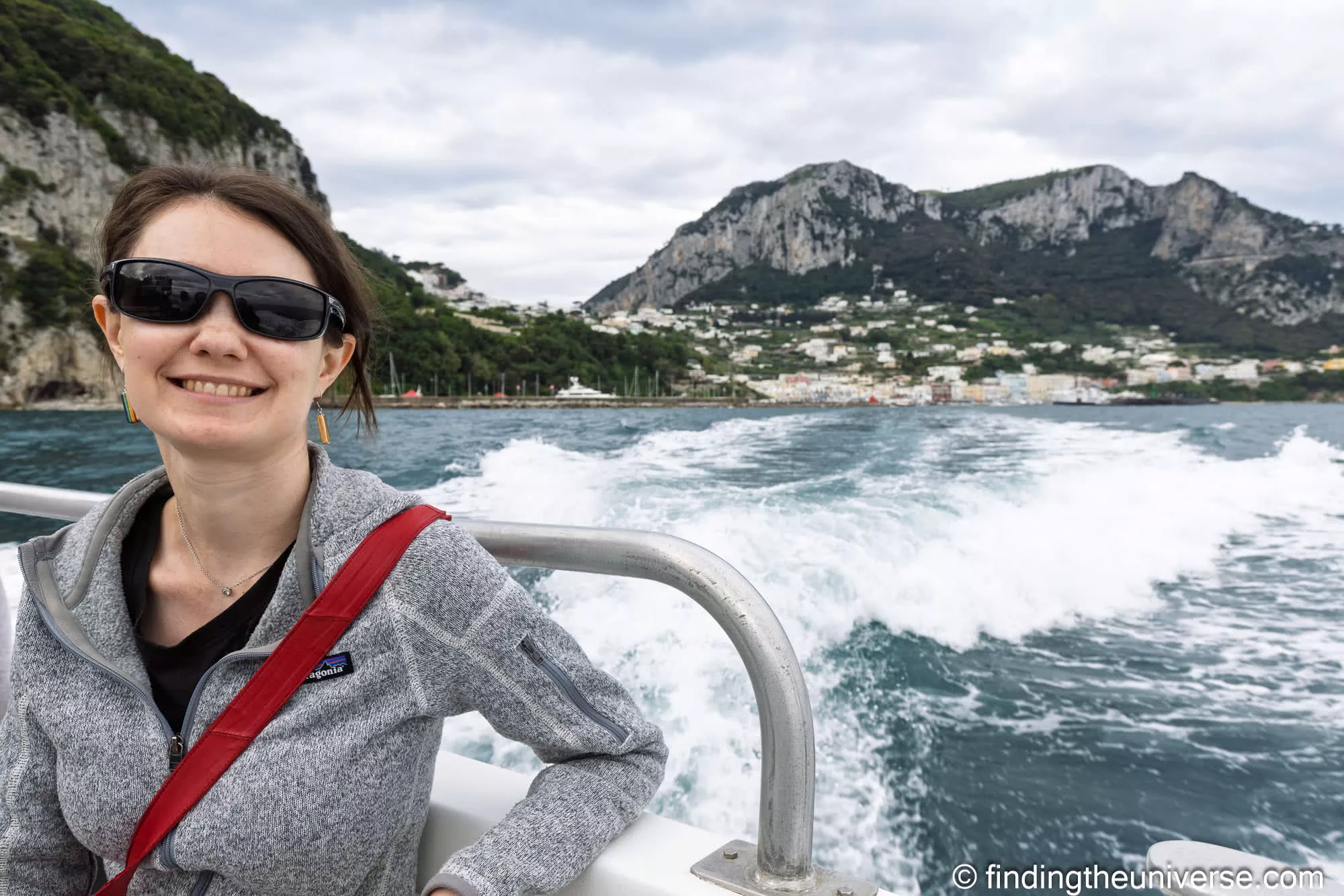 Jess on the early ferry to Capri, the island rising behind