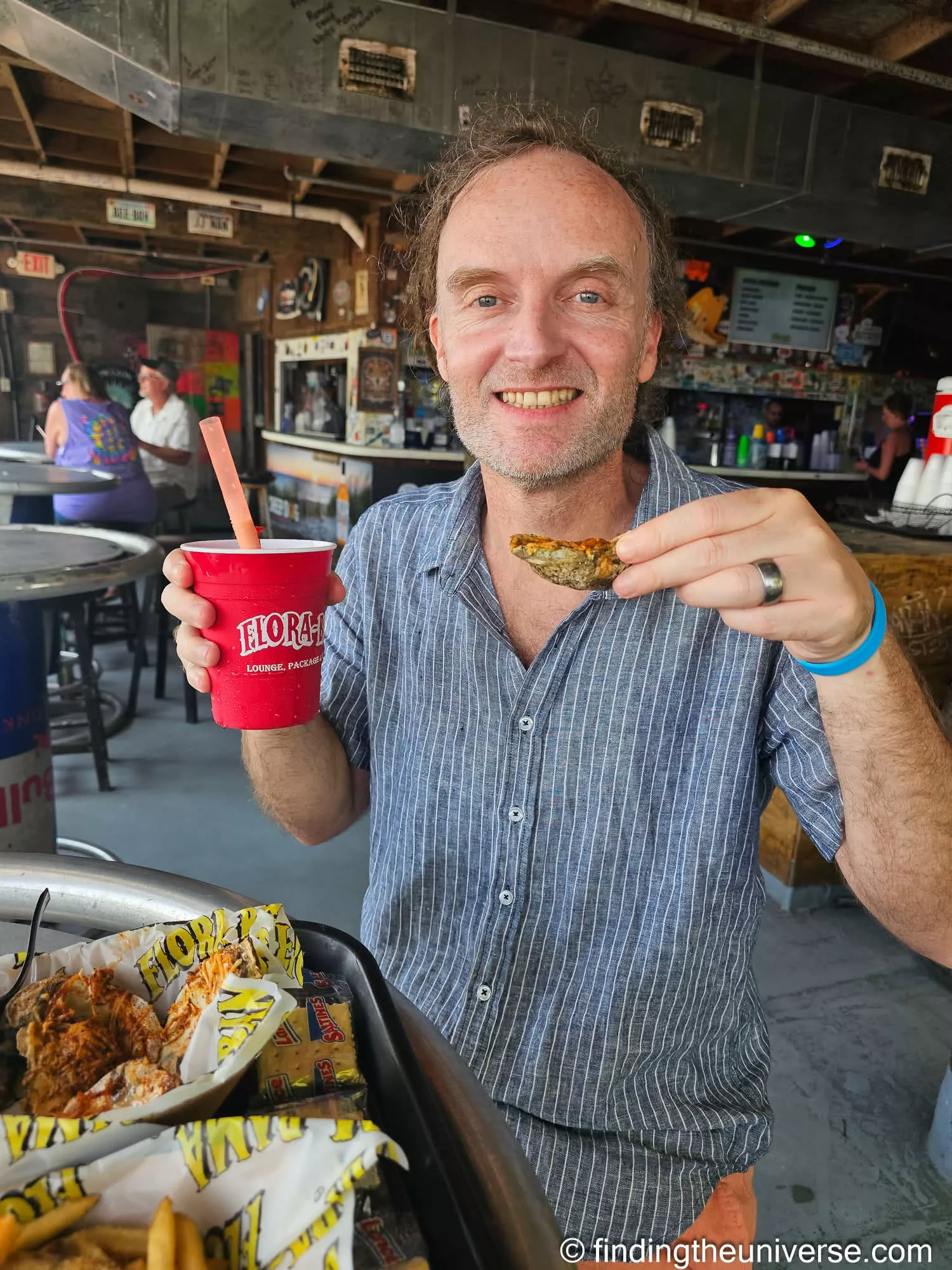 A chargrilled oyster and a Bushwacker at the Flora-Bama