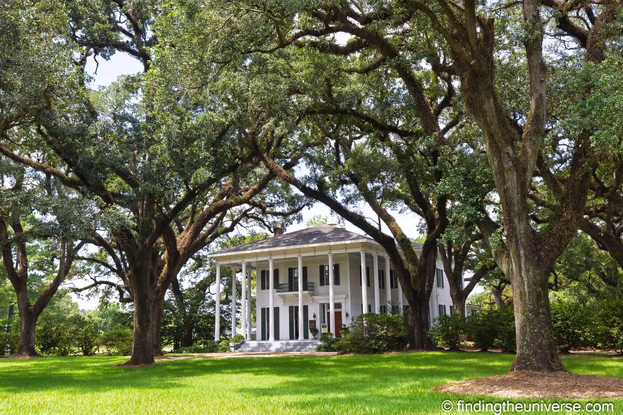 Bragg-Mitchell Mansion behind its live oaks, closed on a Saturday