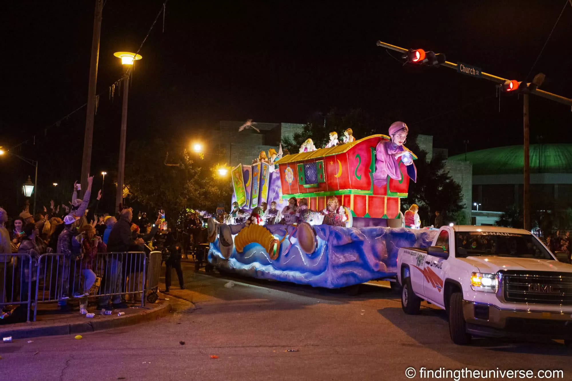 Crowds behind the barriers as a Mardi Gras float passes on Church Street