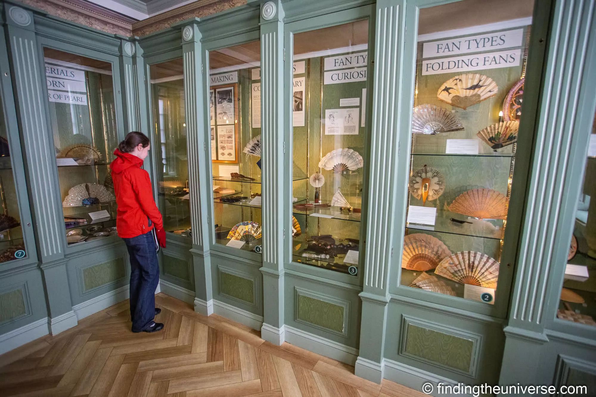 Visitor looking at folding fans in a display gallery at the Fan Museum, Greenwich