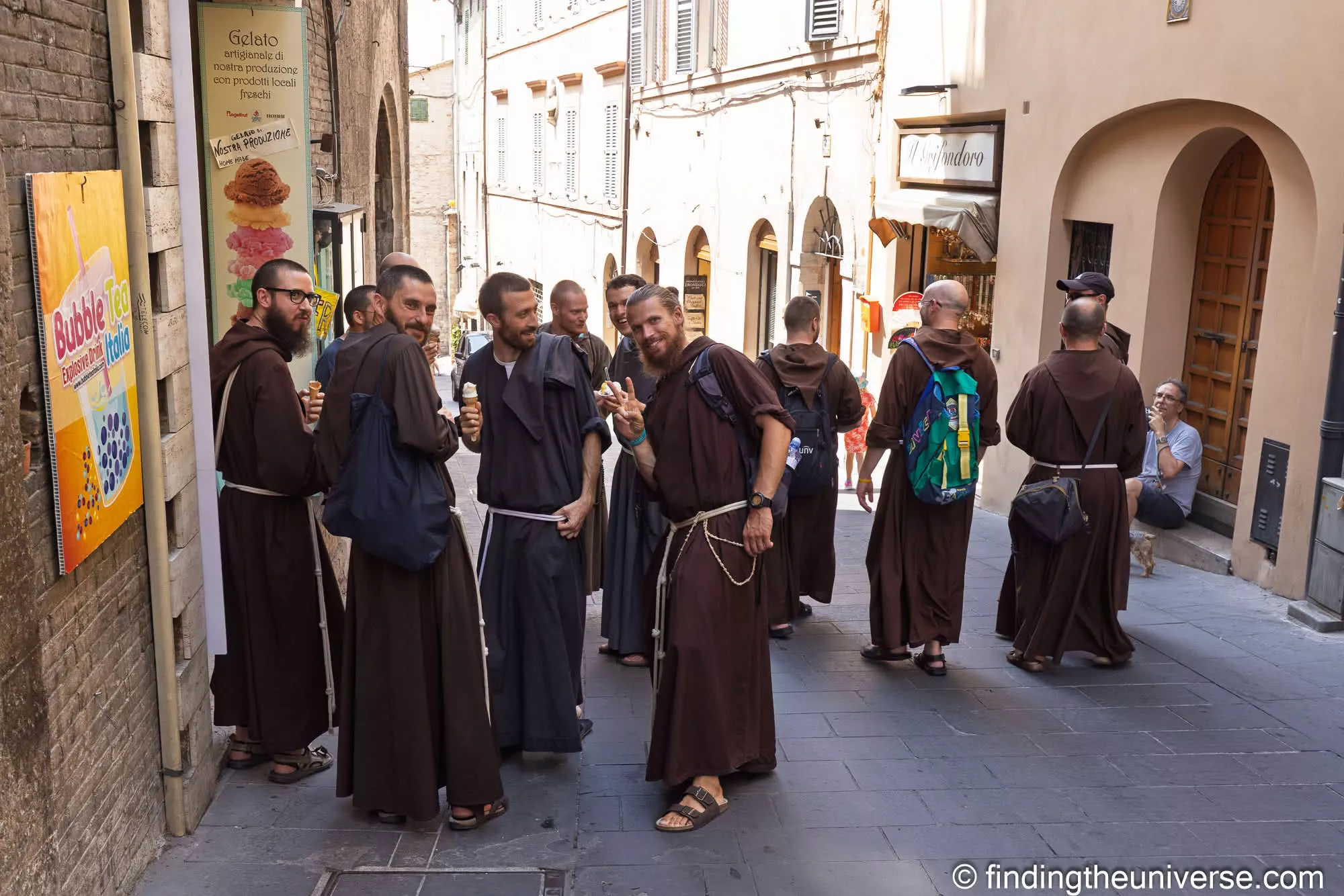 Franciscan friars with gelato on a street in Assisi
