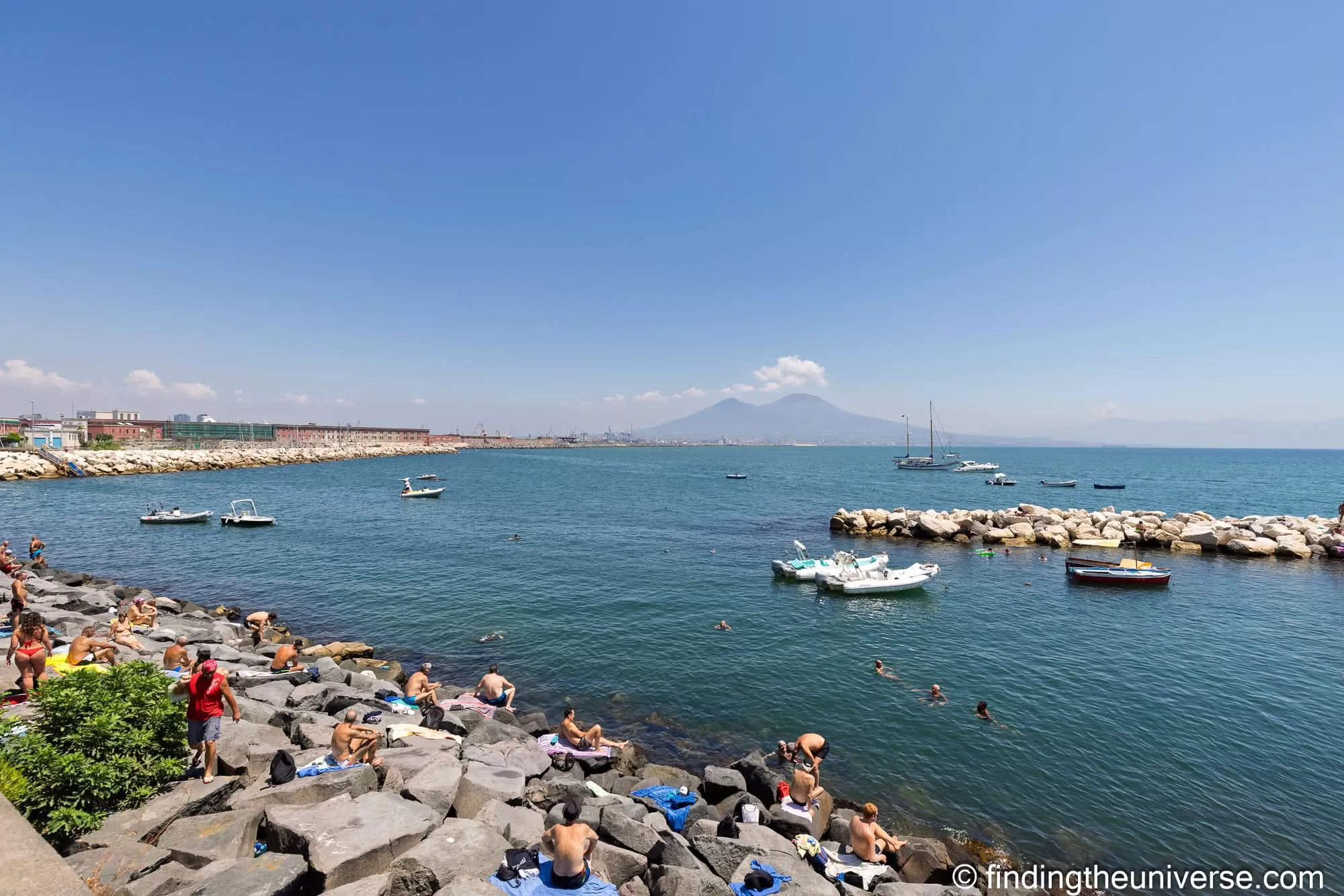 View of Vesuvius from Naples waterfront with people bathing
