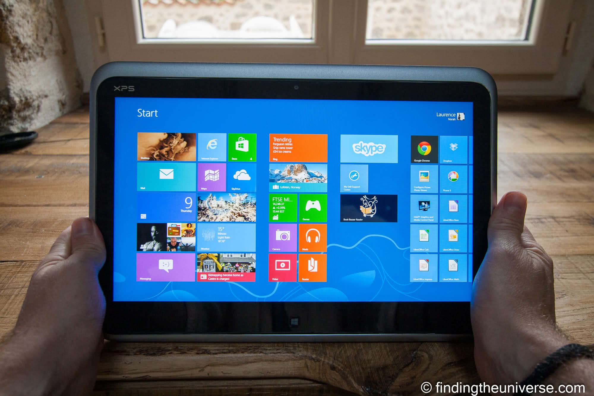 Windows tablet held in hands for photo editing
