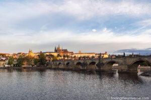 Charles Bridge and Prague Castle at dawn across the Vltava
